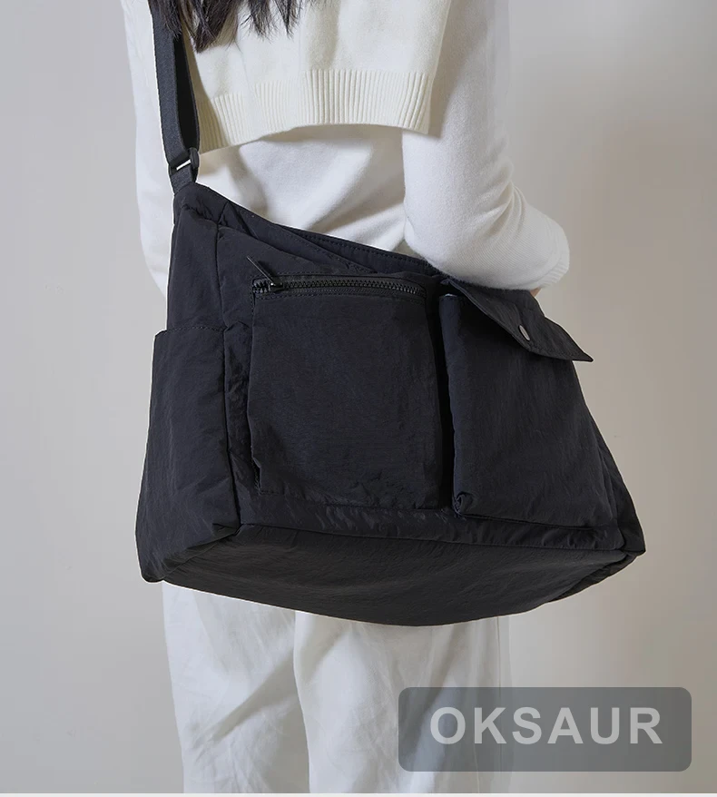 Black large-capacity crossbody bag worn across the body
