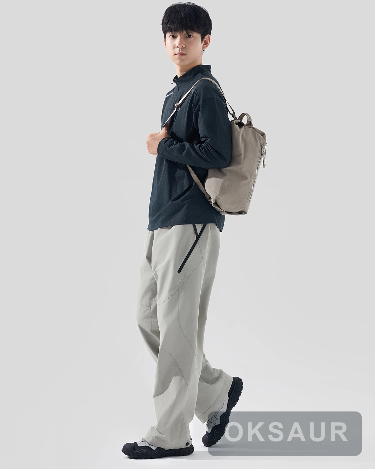 Beige square sports bag carried beside the body