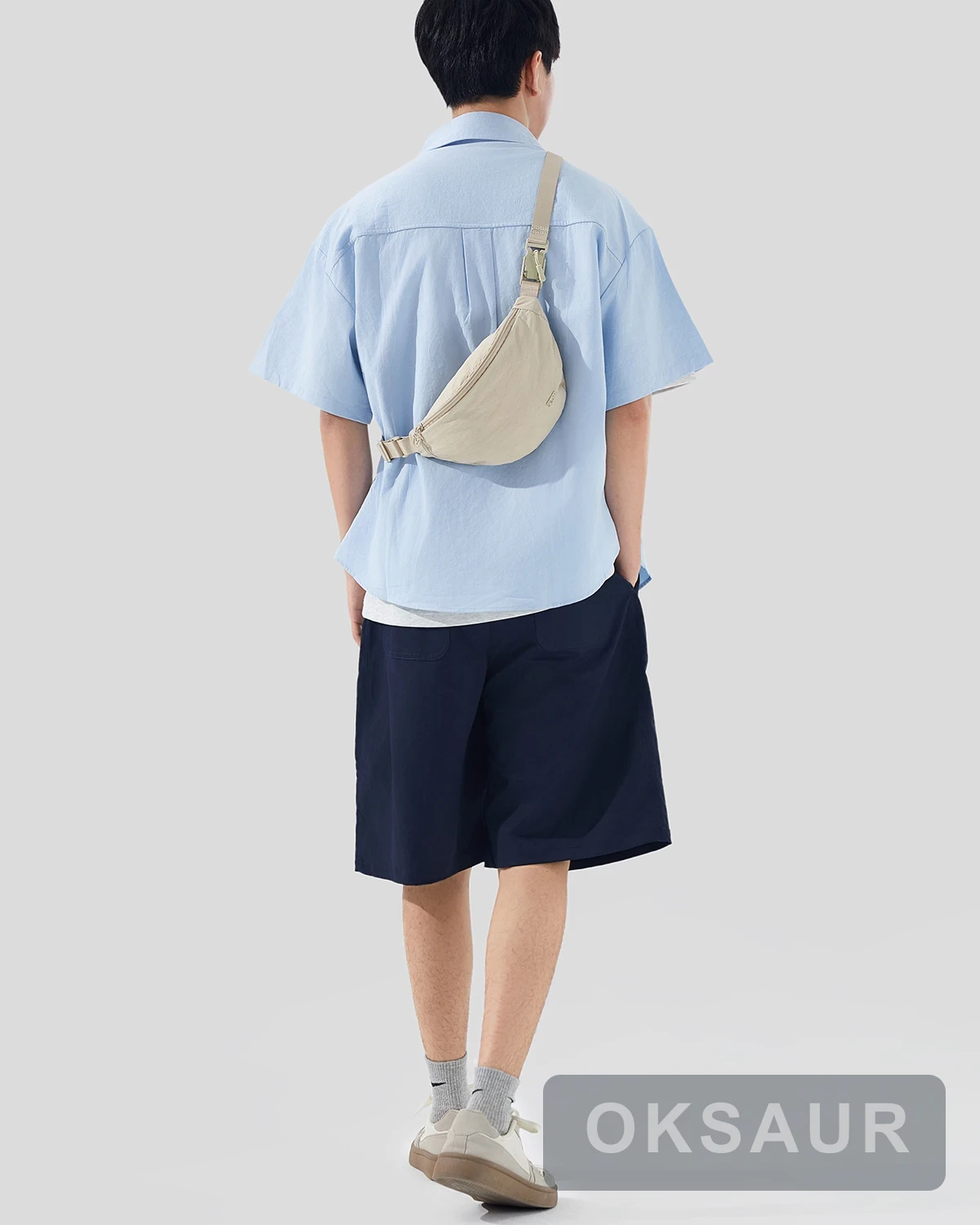 Cream crescent shoulder bag shown from the rear