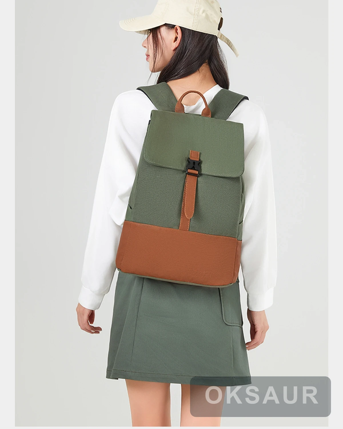 Two-tone canvas travel backpack worn from the back