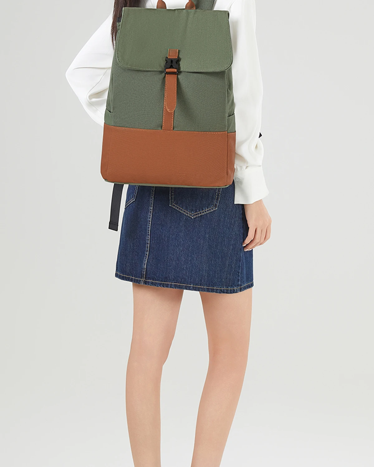 Two-tone canvas travel backpack worn on a model