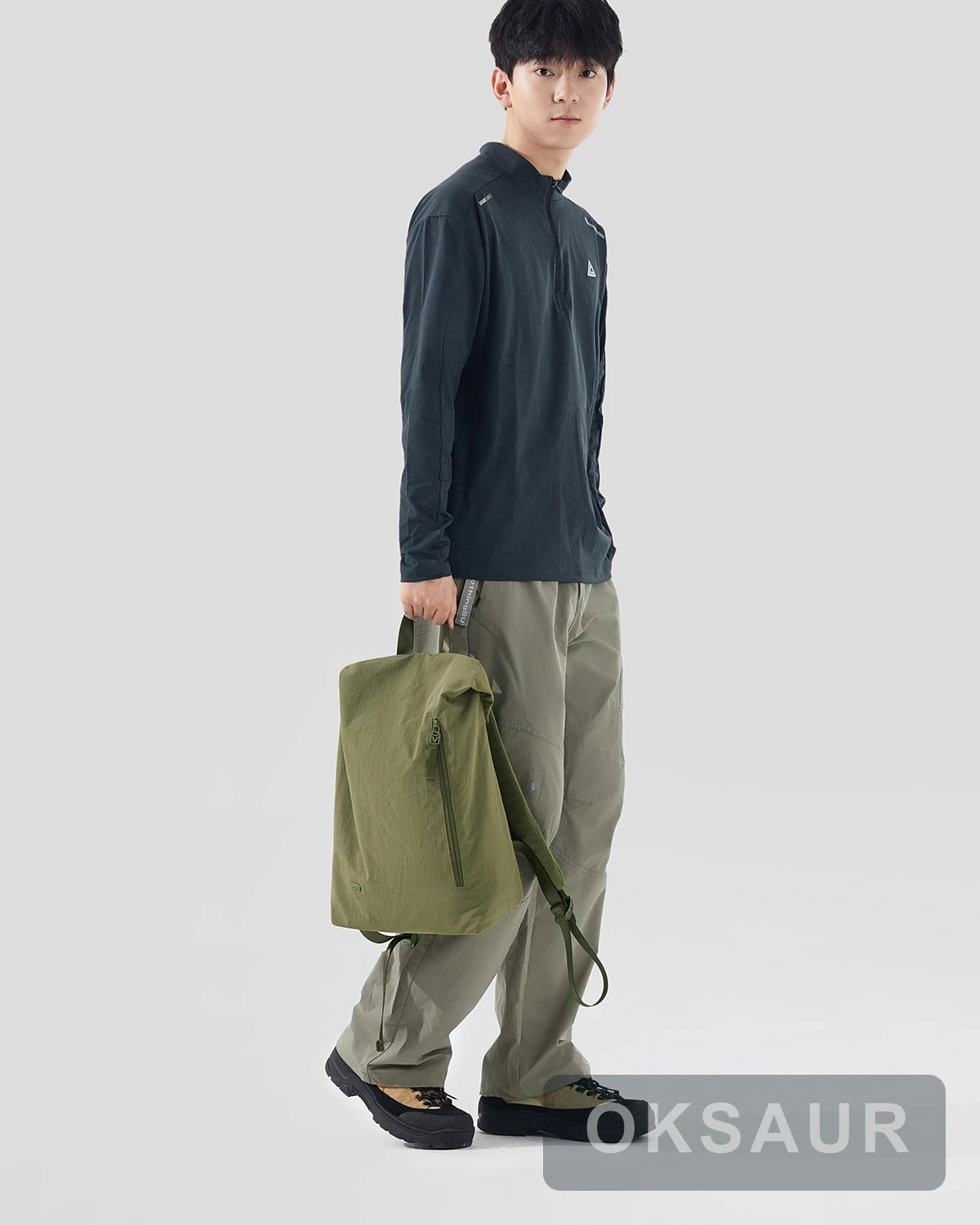 Olive lightweight backpack carried by hand