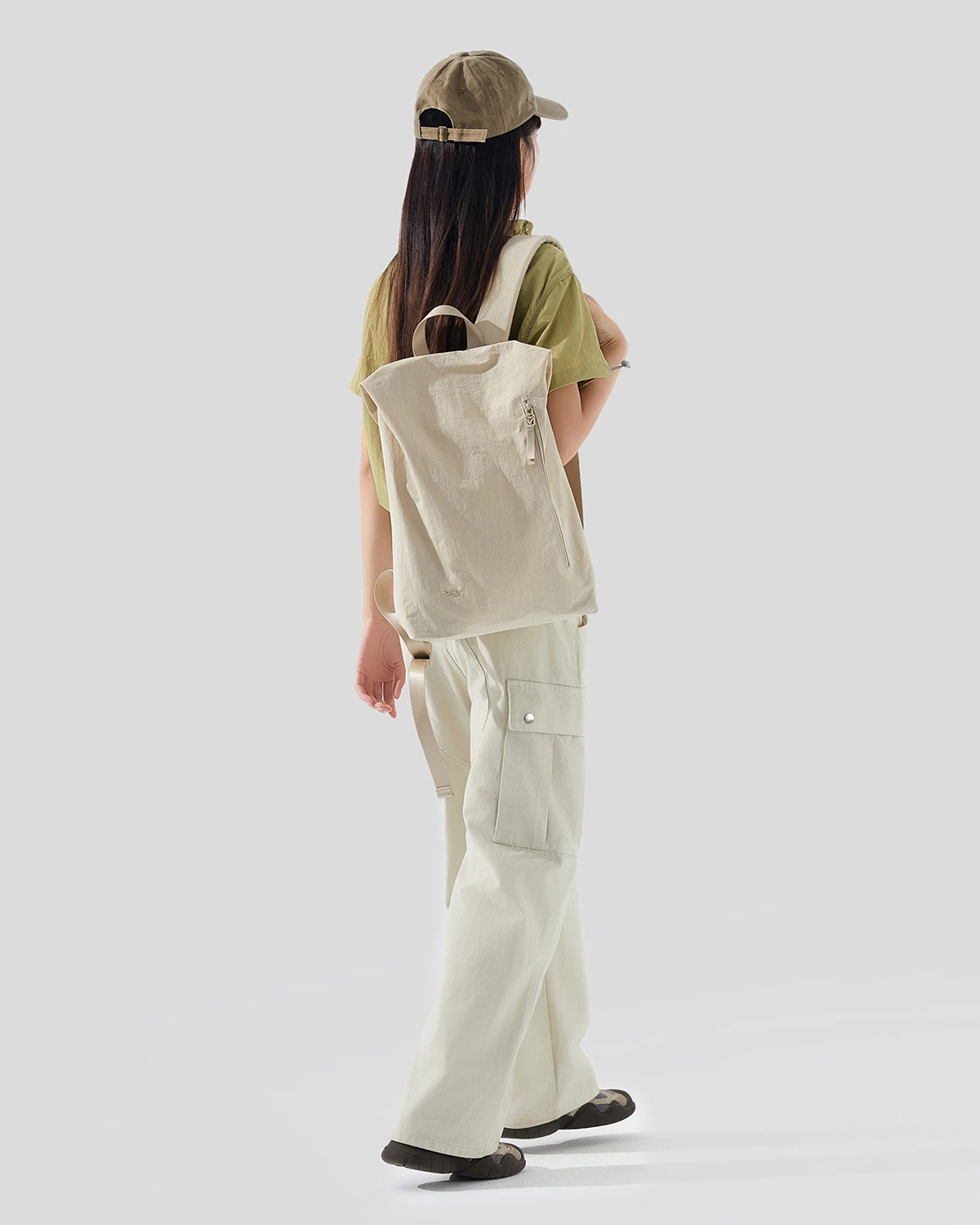 Warm white lightweight anti-theft backpack worn on a model