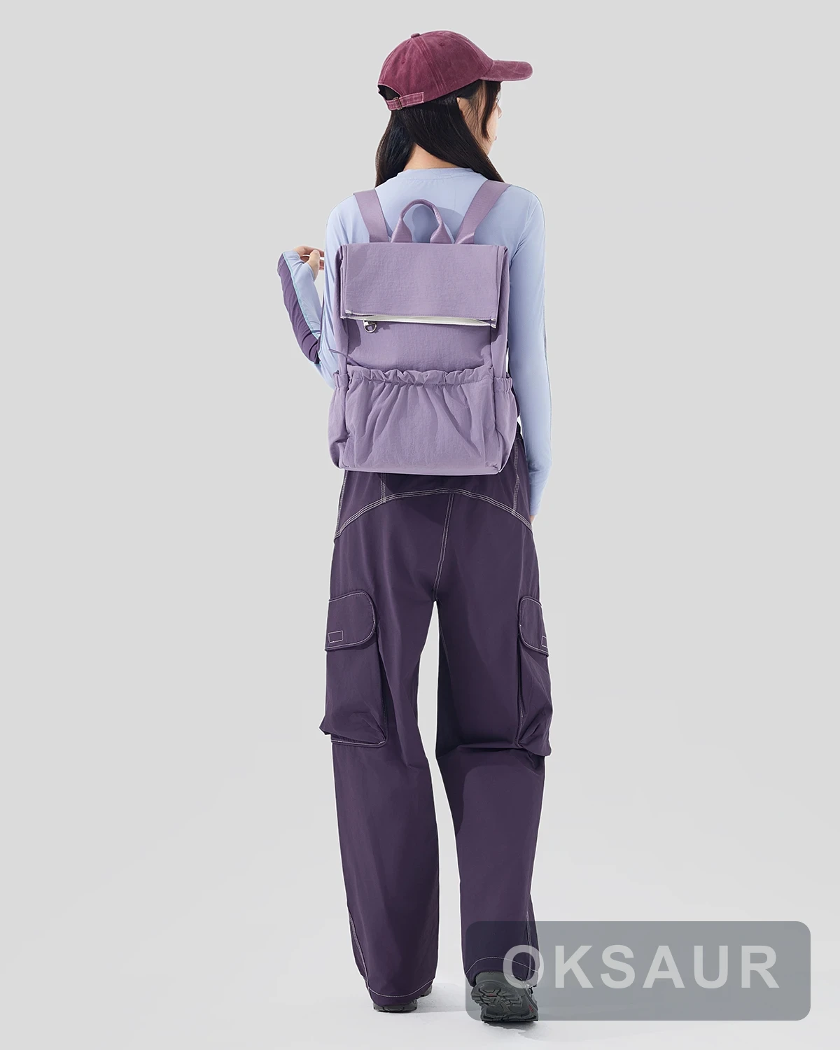 Purple pocket backpack worn from the rear