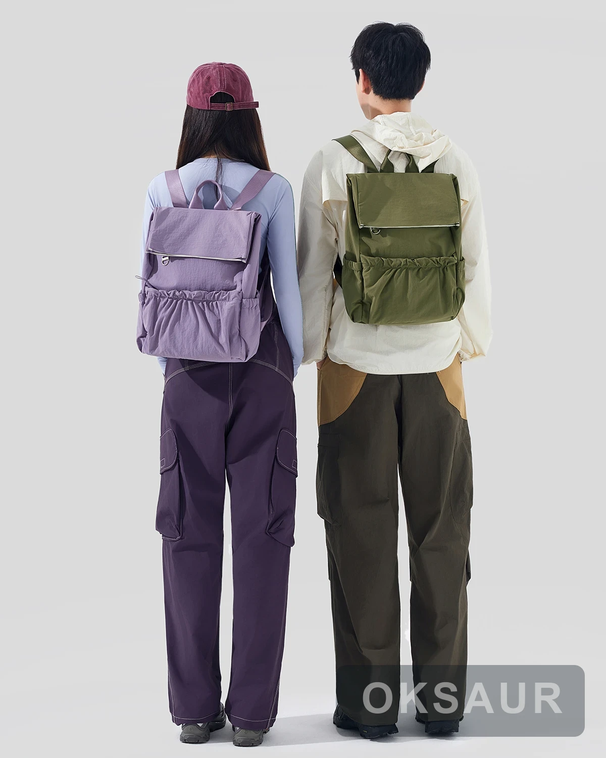 Purple and olive pocket backpacks shown together