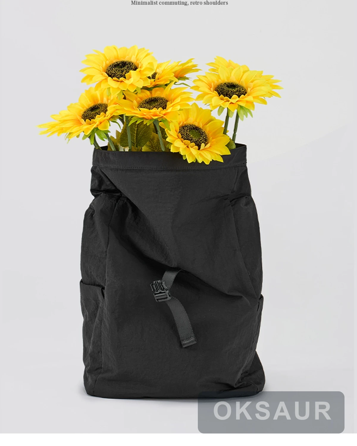 Black roll-top backpack used as a lightweight daily carry bag