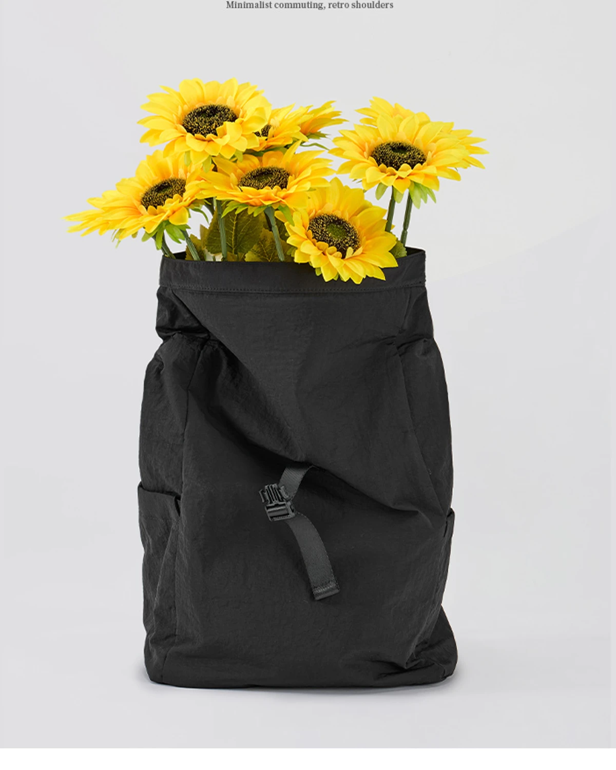 Black MG8010 roll-top commuter backpack with a buckle closure
